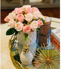pink roses in a vase on a coffee table