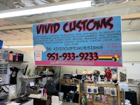 a store with a sign that says vivd customs