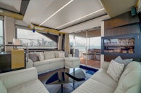 the living room of a luxury yacht with a view of the city