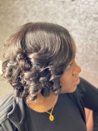 a woman with curly hair in a salon