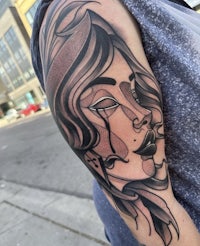 a tattoo with a woman's face on it