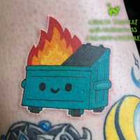 a tattoo of a blue box with fire on it