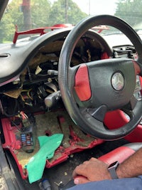 a man is working on the steering wheel of a car