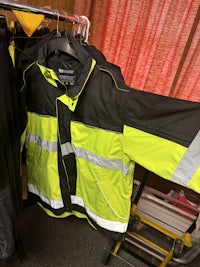 a yellow and black jacket hanging on a rack