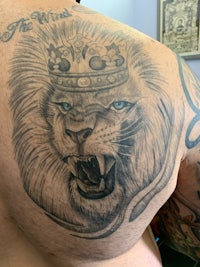 a man with a lion tattoo on his back