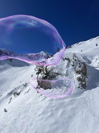 soap bubbles in the air over a snow covered mountain