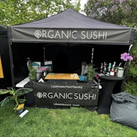 a tent with a sign that says organic sushi