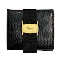 a black python wallet with a gold clasp