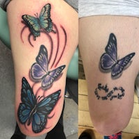 a woman's thigh with two butterflies tattooed on it
