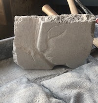 a piece of concrete sitting on a workbench