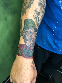 freddy krueger tattoo on a man's arm
