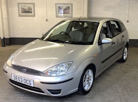 a silver ford focus parked in a garage