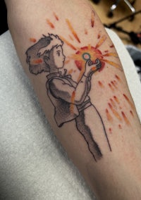a tattoo of a boy holding a fireball