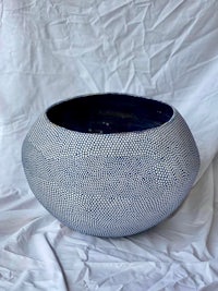 a blue and white bowl sitting on a white surface
