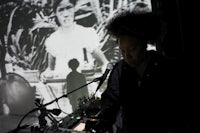a woman with afro hair in front of a projector