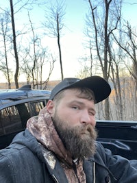 a bearded man with a beard in a pickup truck