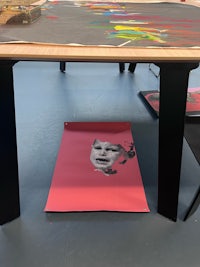 a painting on a table next to a chair