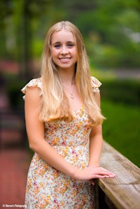 a young woman in a floral dress is posing for a photo