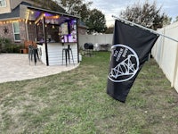 a backyard bar with a flag in the background