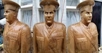 a wooden statue of a man in uniform