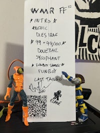a note with a qr code on it next to a toy