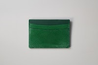 a green card holder on a white surface