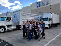 a group of people posing in front of a white truck