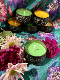 a group of candles with chalk writing on them
