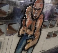 a graffiti painting of a man holding a boxing glove