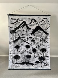 a black and white drawing hanging on a wall