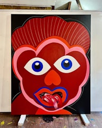 a painting of a red face with blue eyes