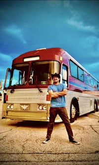 a man standing in front of a bus