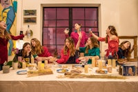 a group of women are sitting around a table