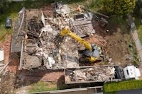 an aerial view of a house being demolished