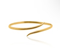 a gold bangle with a curved design