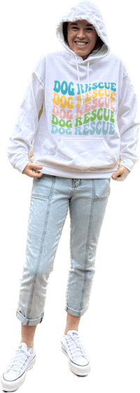 a woman wearing a white hoodie that says dog is a rescue