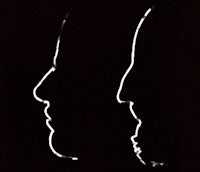 two silhouettes of a man and a woman on a black background