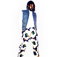 a man with dreadlocks wearing colorful pants