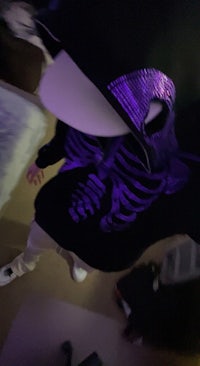 a person wearing a skeleton hoodie