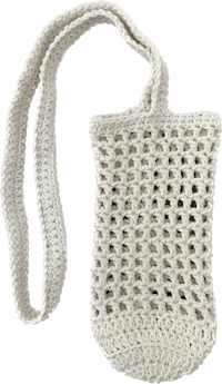 a white crocheted bag on a black background