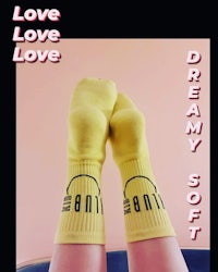 a pair of yellow socks with the words love love dream soft