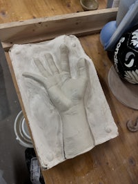 a clay sculpture of a hand on a table
