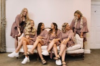 a group of bridesmaids sitting on a couch