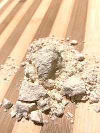 a pile of white powder on a wooden table