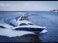 a blue and white motor boat traveling on the water