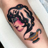a tattoo of a woman with a lamp on her leg