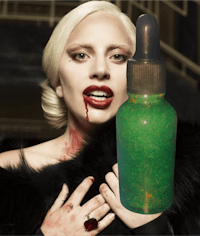 a woman holding a bottle of green liquid