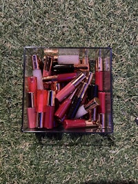 a box of lipsticks sitting on the grass