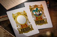 two playing cards with the jokers logo on them