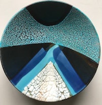 a bowl with a blue and black design on it